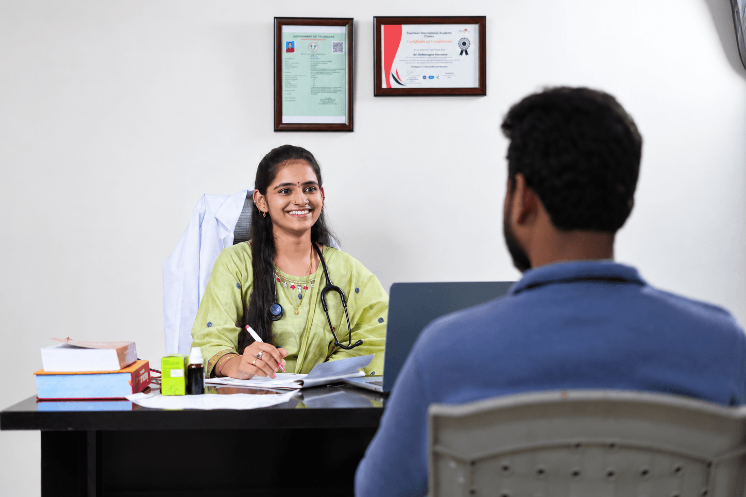 Dr. Harshini speaking with a patient during a clinic consultation